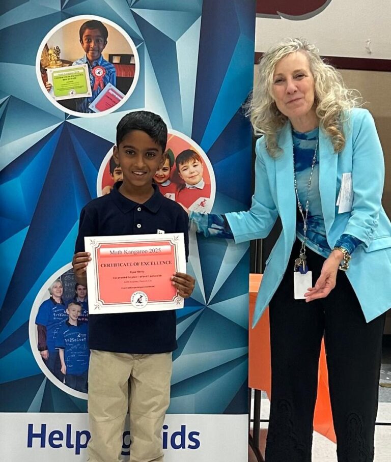 Ryan proudly holding his Math Kangaroo certificate for a perfect score.