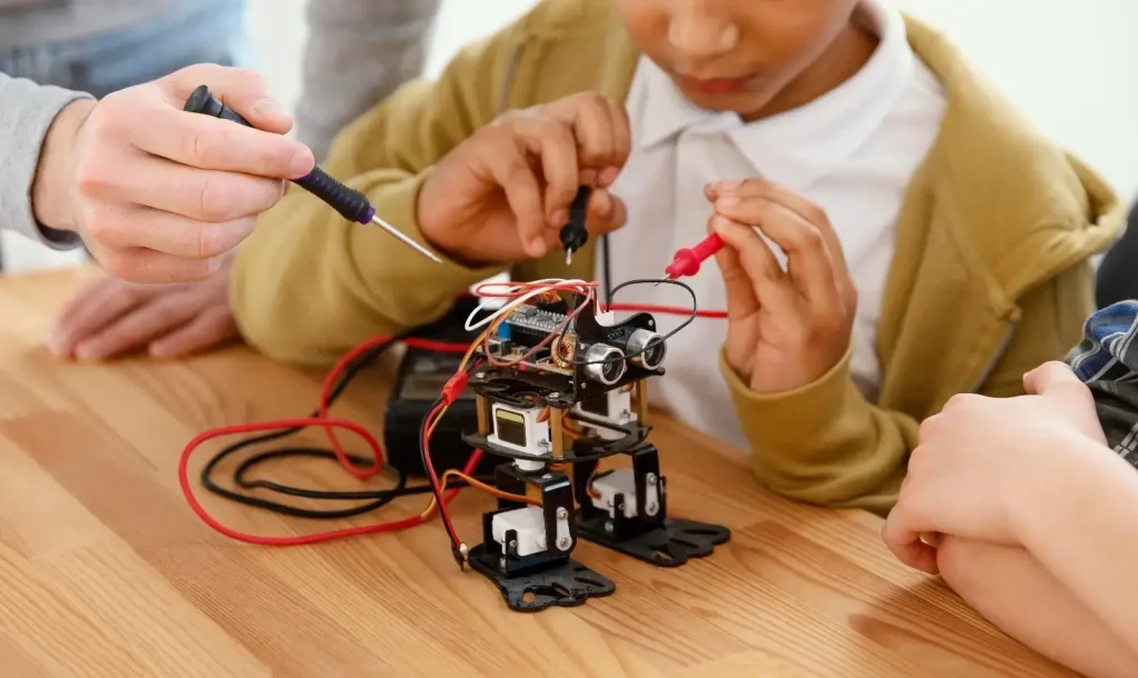A child works with small electronic components.